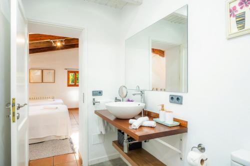 a bathroom with a sink and a mirror at Finca Rural Es Pujol in Sóller