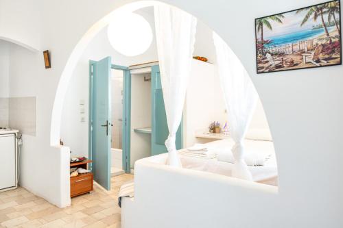 a room with a bed and a mirror at Beachfront Lampis Dolphin 1 in Skala