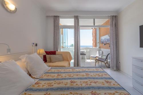 a bedroom with a bed and a living room at Marina view apartment in Fuengirola