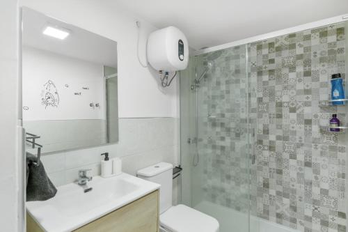 a bathroom with a toilet and a sink and a shower at Daniel House in Mogán