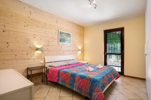 a bedroom with a bed and a wooden wall at Maison Chateau Chatillon in Châtillon