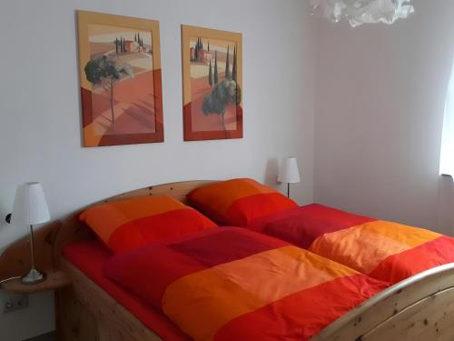 a bedroom with two beds with colorful blankets at Haus Maruna in Schauenburg