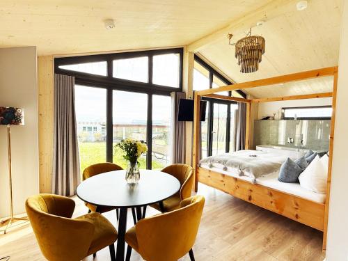 a bedroom with a bed and a table and chairs at Ferienhäuser Saalemaxx in Rudolstadt