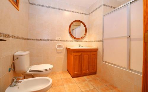 a bathroom with a toilet and a sink and a mirror at Can Palea in Campos