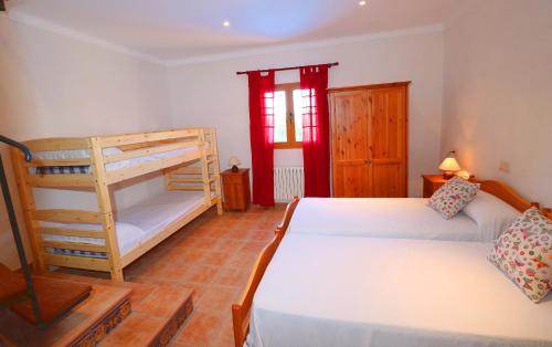 a bedroom with two bunk beds and a window at Can Palea in Campos