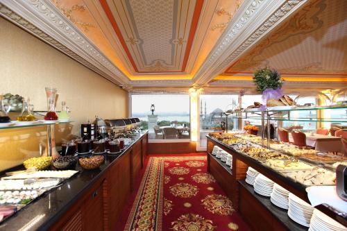 a buffet line in a restaurant with food on display at Deluxe Golden Horn Sultanahmet Hotel in Istanbul