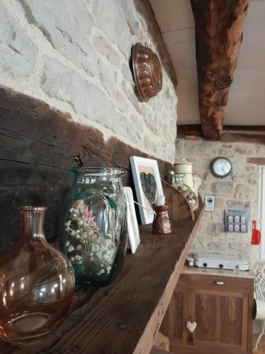 a large glass vase sitting on a wooden counter at La Petite Authentique in Gaillac-dʼAveyron
