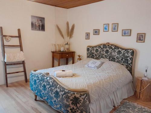 a bedroom with a bed and a chair in it at La Petite Authentique in Gaillac-dʼAveyron