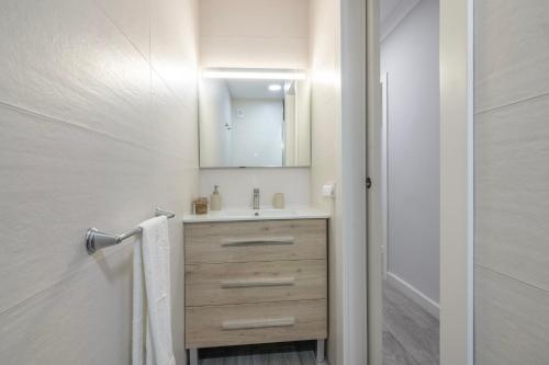 a bathroom with a sink and a mirror at Grey House in Huelva