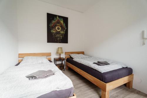 two beds sitting next to each other in a room at Apartment 19 in Schutterwald