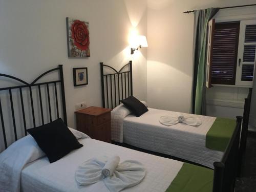 two beds in a hotel room with bows on them at Casa Paula in Yaiza