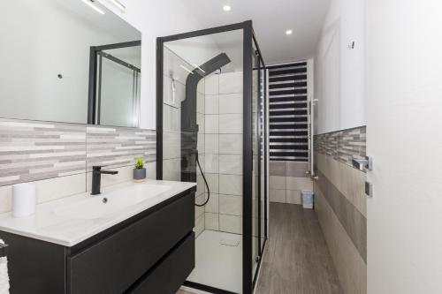 a bathroom with a sink and a shower at Casa Gioiosa Holidays in Gioiosa Marea