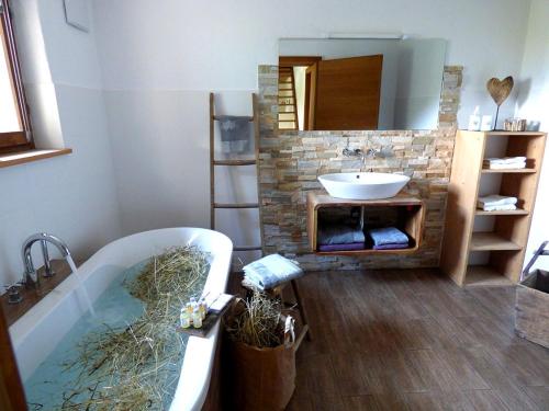a bathroom with a bath tub and a sink at Bergchalet h e i m a t in San Martino