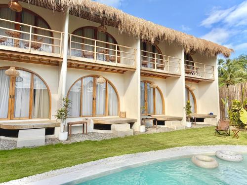 a villa with a swimming pool in front of it at Laya Boutique Hotel in General Luna