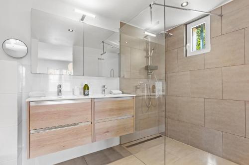 a bathroom with a sink and a shower at La Petite Maison Jaune in Grimaud