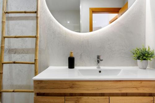 a bathroom with a sink and a mirror at Ti Clara View Apartment in Caniço