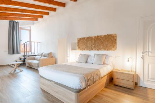 a bedroom with a large bed and a chair at Son Guillem in Son Sardina