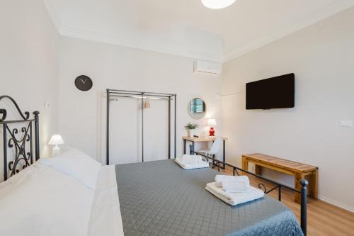 a bedroom with a bed and a flat screen tv at Ardesia Vacanze in Valderice