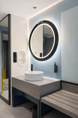 a bathroom with a sink and a mirror at Ibis Styles Subic in Olongapo