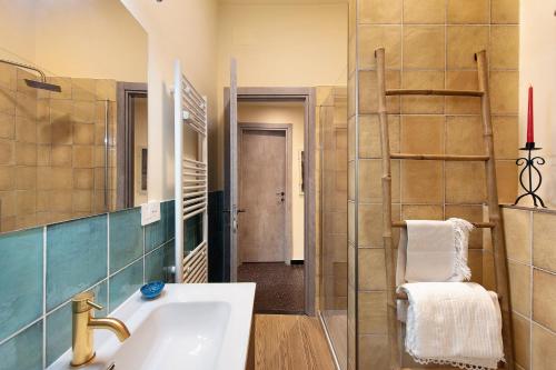 a bathroom with a sink and a mirror at Case Sole e Luna in Genoa