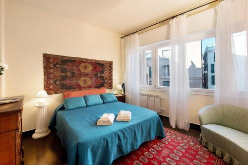 a bedroom with a bed with two towels on it at Case Sole e Luna in Genoa