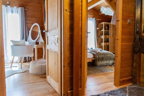 a room with wooden walls and a room with a bed at Chambre D'hôte au Chalet Datcha in Briançon