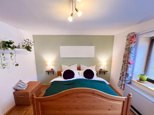 a bedroom with a bed with two dogs laying on it at Ferienwohnung Immergrün in Stetten am Kalten Markt