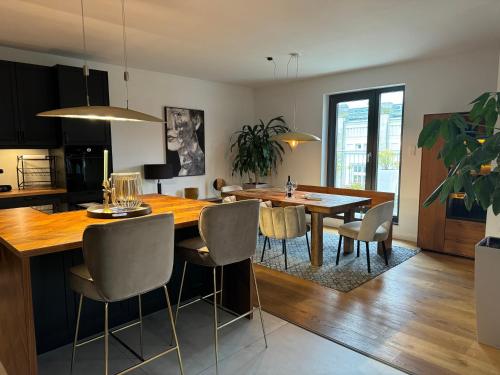 a kitchen and dining room with a table and chairs at 180qm Penthouse mit Sonnenterrasse in Rostock