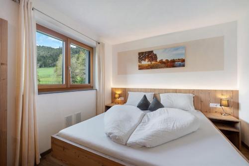 a bedroom with a white bed and a window at Waldheim in Verano
