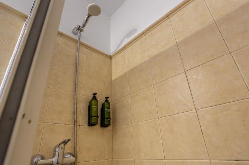 two green bottles are sitting in a shower at Casa Abuela Maruca in Corralejo