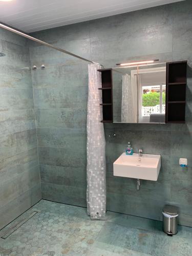 a bathroom with a sink and a mirror at Beach Bungalow in Torrox