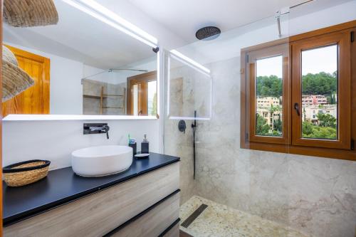 a bathroom with a white sink and a shower at Villa Carla in Port de Soller