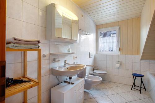a bathroom with a sink and a toilet at Ferienwohnung Hildegard in Rappersweier