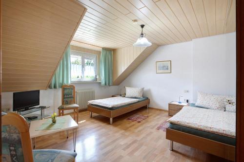 a living room with a bed and a couch at Ferienwohnung Hildegard in Rappersweier