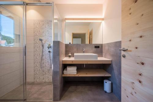 a bathroom with a sink and a shower at Sommersbergerhof 1968 in Bressanone