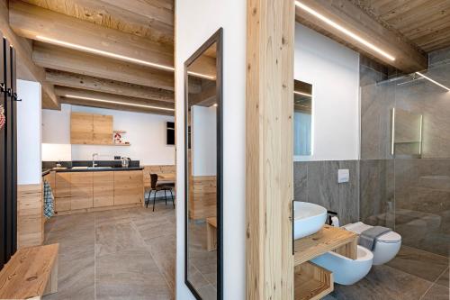 a bathroom with a sink and a mirror at Lòni Lodge Vermiglio in Vermiglio