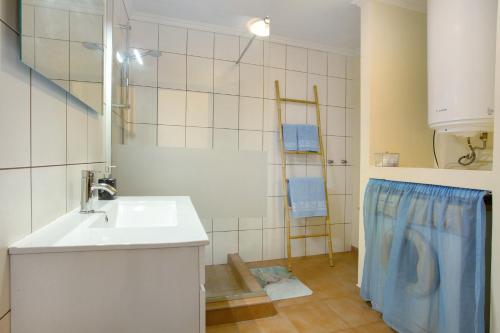 a bathroom with a sink and a shower at Levada Residence in Funchal