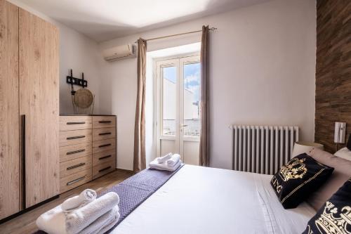 a bedroom with a large bed with towels on it at Narcê – Coastal Retreat in Porto Cesareo