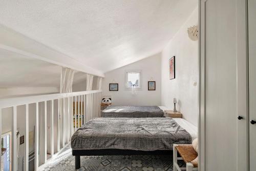 a bedroom with two beds in a attic at M112 - L'orée Du Golf in Pornic