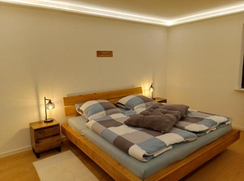 a bedroom with a large bed with two pillows at Ferienwohnung Wandersnest in Gersfeld