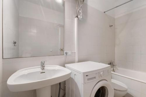 a white bathroom with a sink and a washing machine at 418 Panoramic View Playa Paraiso in Adeje