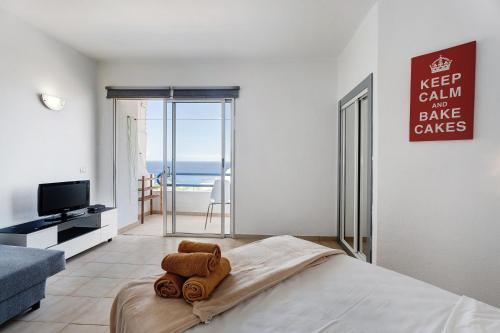 a bedroom with a bed with a towel on it at 418 Panoramic View Playa Paraiso in Adeje
