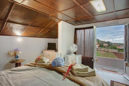 a bedroom with a large bed with a wooden ceiling at Luci's House in São Jorge