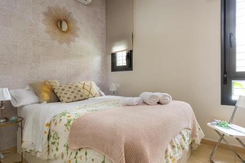 a bedroom with a bed with two towels on it at Apartamento Centro con Parking in Seville