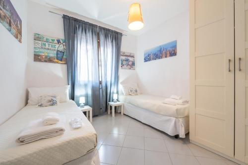 a room with two beds and a window at P012 Apartment in Cagliari