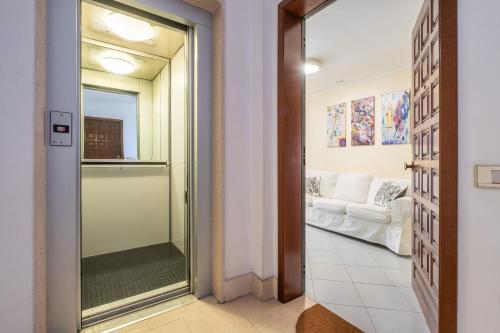 a glass door leading to a living room with a couch at P012 Apartment in Cagliari
