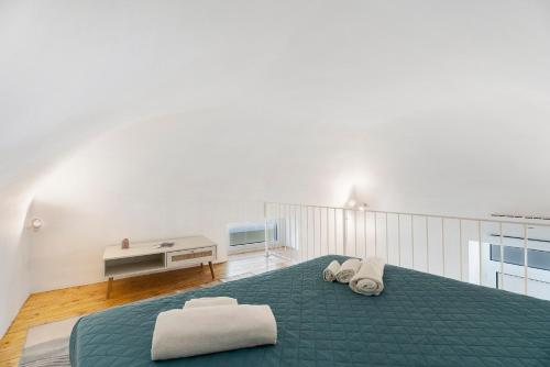 a bedroom with a green bed with two towels on it at Casa Quattrocchi in Barano d'Ischia