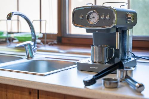 a coffee maker sitting on a kitchen counter next to a sink at vv - La Casa Verde in Las Casas