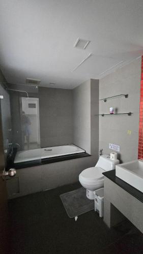 a bathroom with a sink and a toilet and a bath tub at joyful theKrisA205 in Ban Lum Fuang