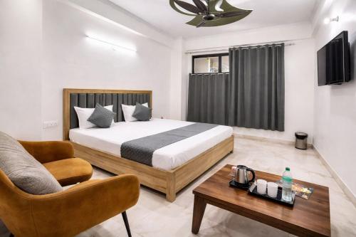 a bedroom with a bed and a couch and a table at Hotel Comfort Inn, Nangloi, Walking from Metro in New Delhi
